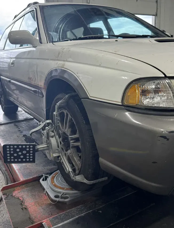 Wheel alignment and brake work on a car in a service bay